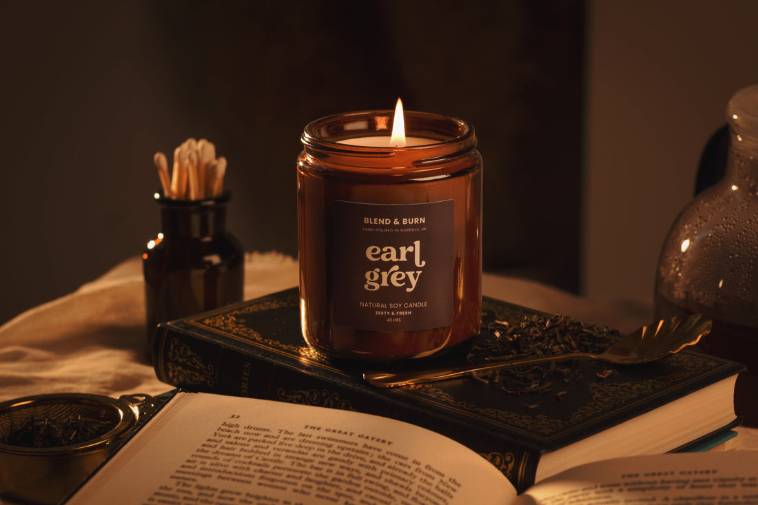Lit Blend & Burn Earl Grey tea scented soy candle on a stack of books, a gift idea for tea lovers